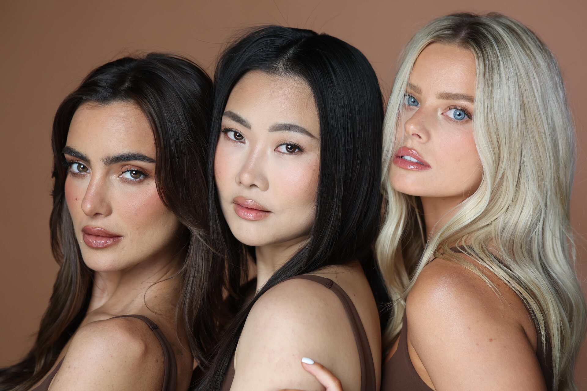 Three women with radiant, even summer skin at Skinsation LA in Los Angeles.